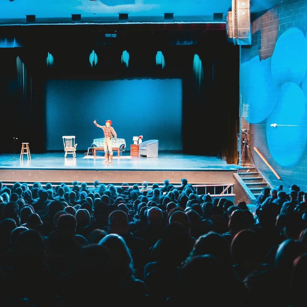 Host on stage in front of a seated audience