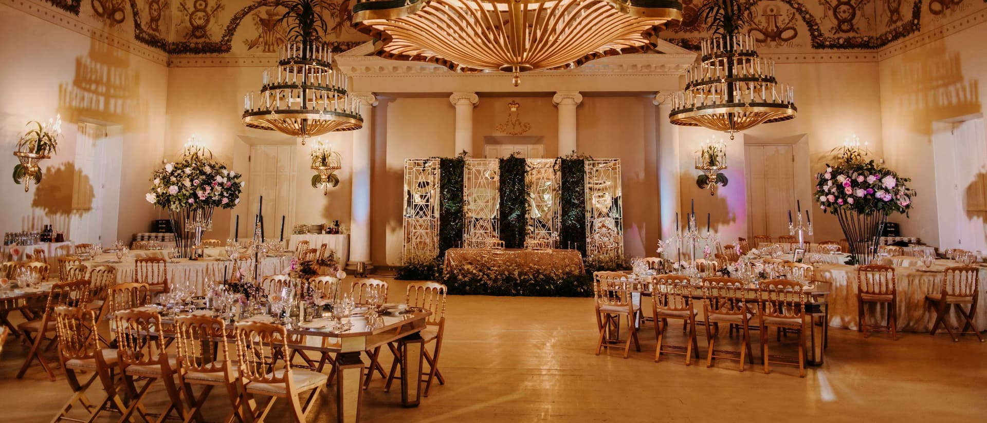 Banquet hall dressed with chandeliers and styled tables