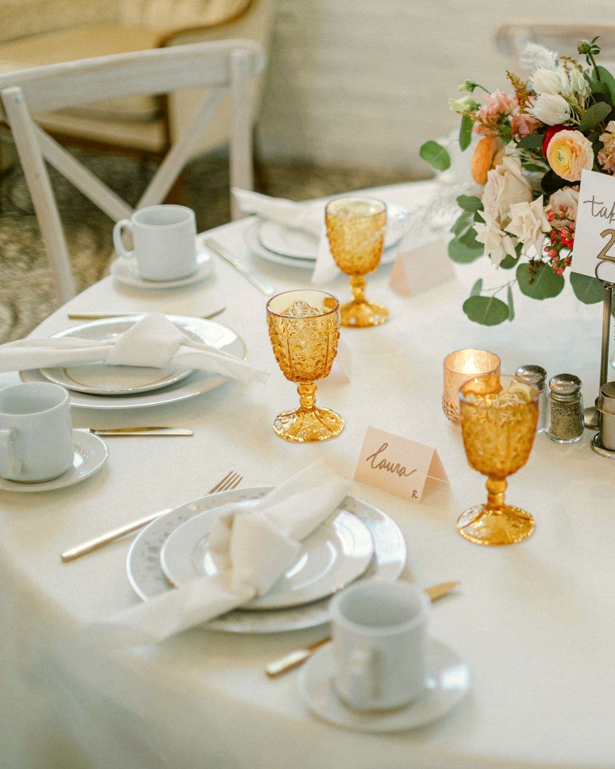 Table styled with a floral centrepiece for a private dinner