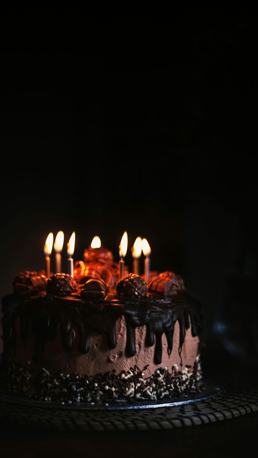 Candlelit cake brought out at an evening celebration