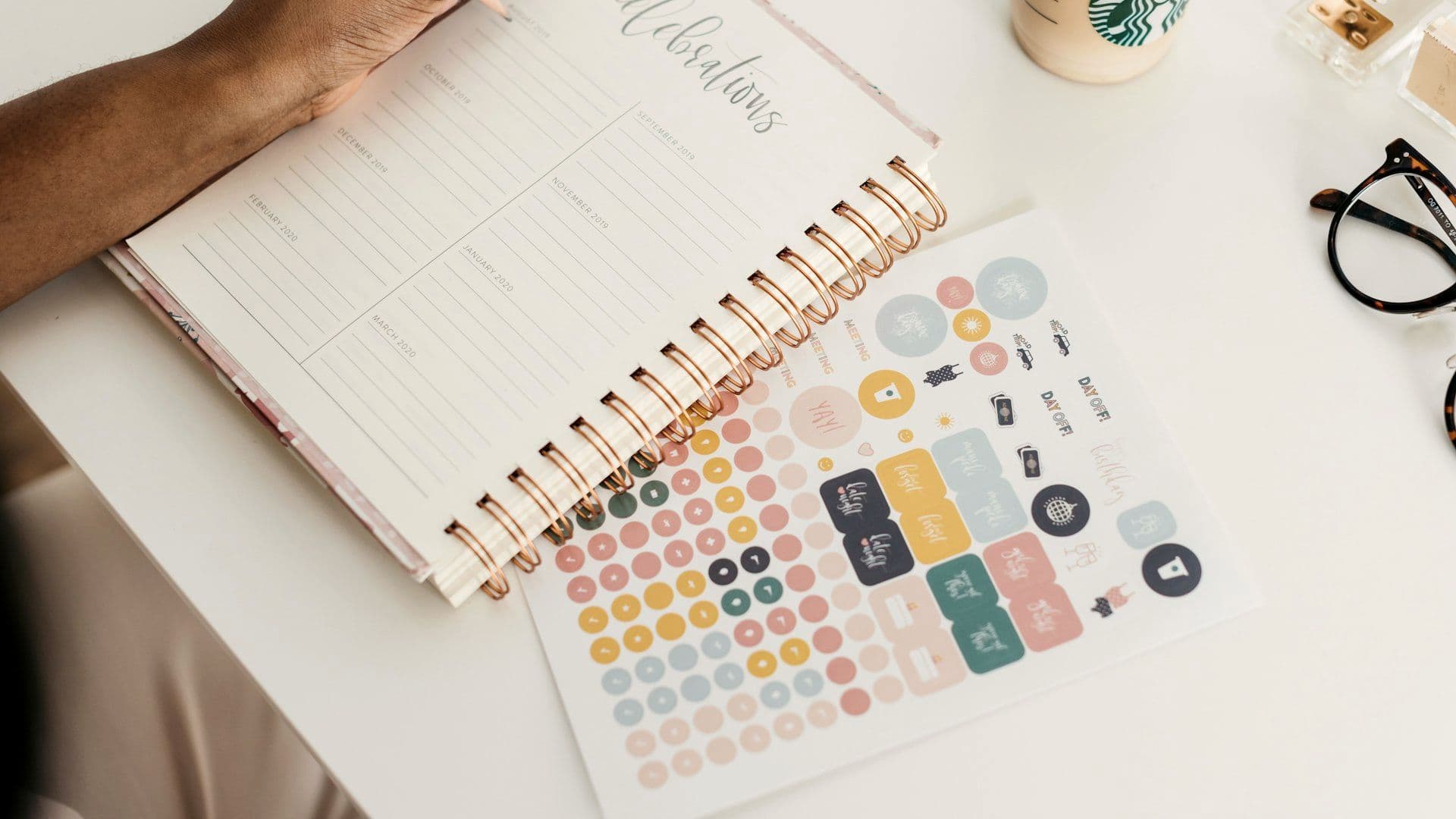 Planner writing notes while preparing an event
