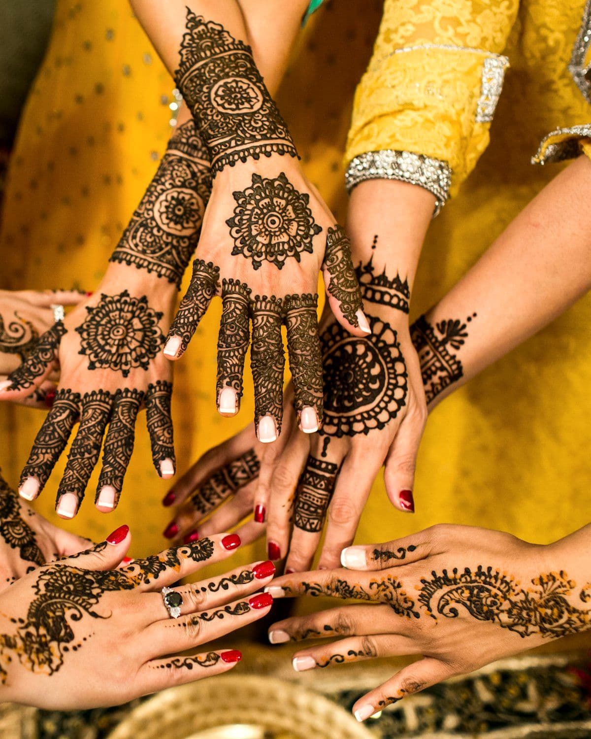 Guests showing hands decorated with intricate mehendi