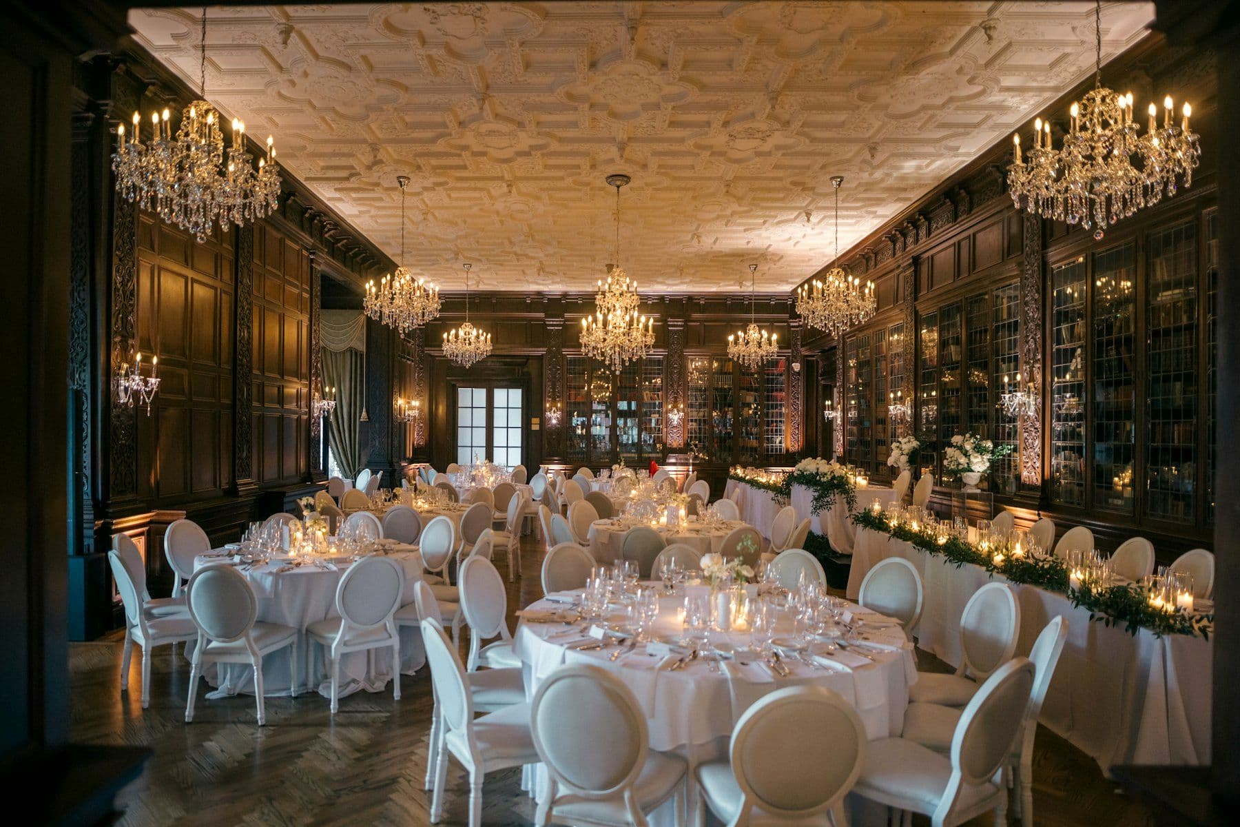 Ballroom lit by chandeliers and warm accent light
