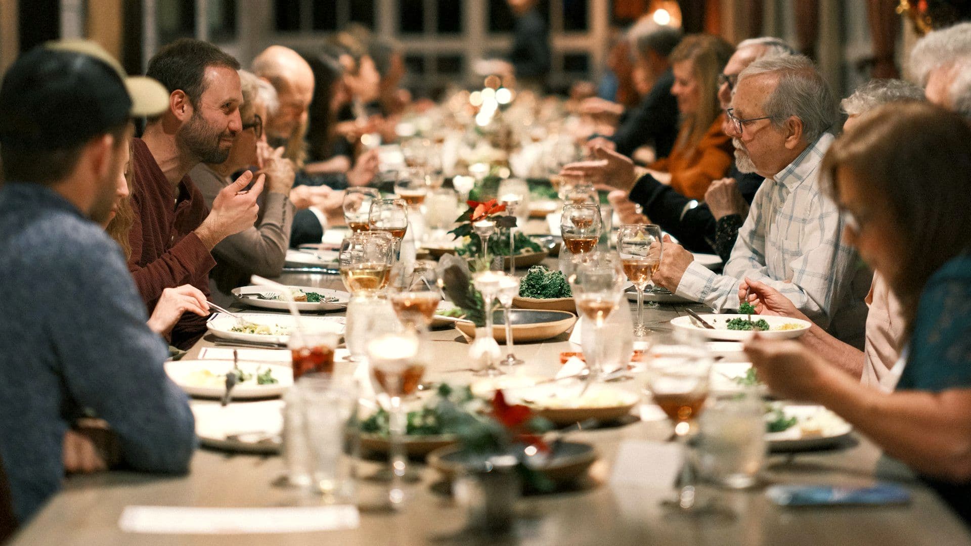 Guests seated along one long open-air table