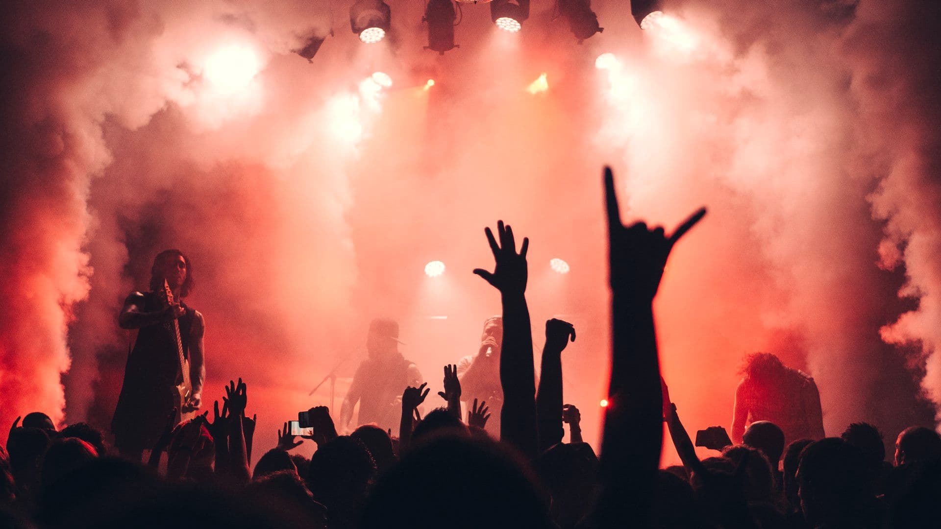 Band performing to a crowd at an evening event