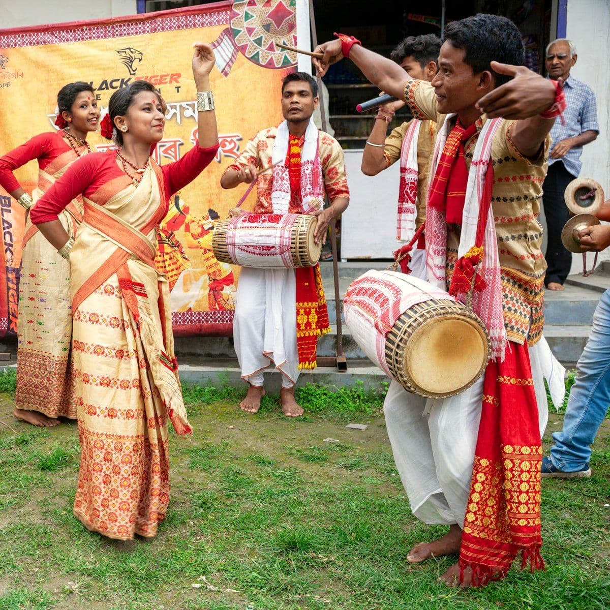 Performers in traditional attire dancing to live drums