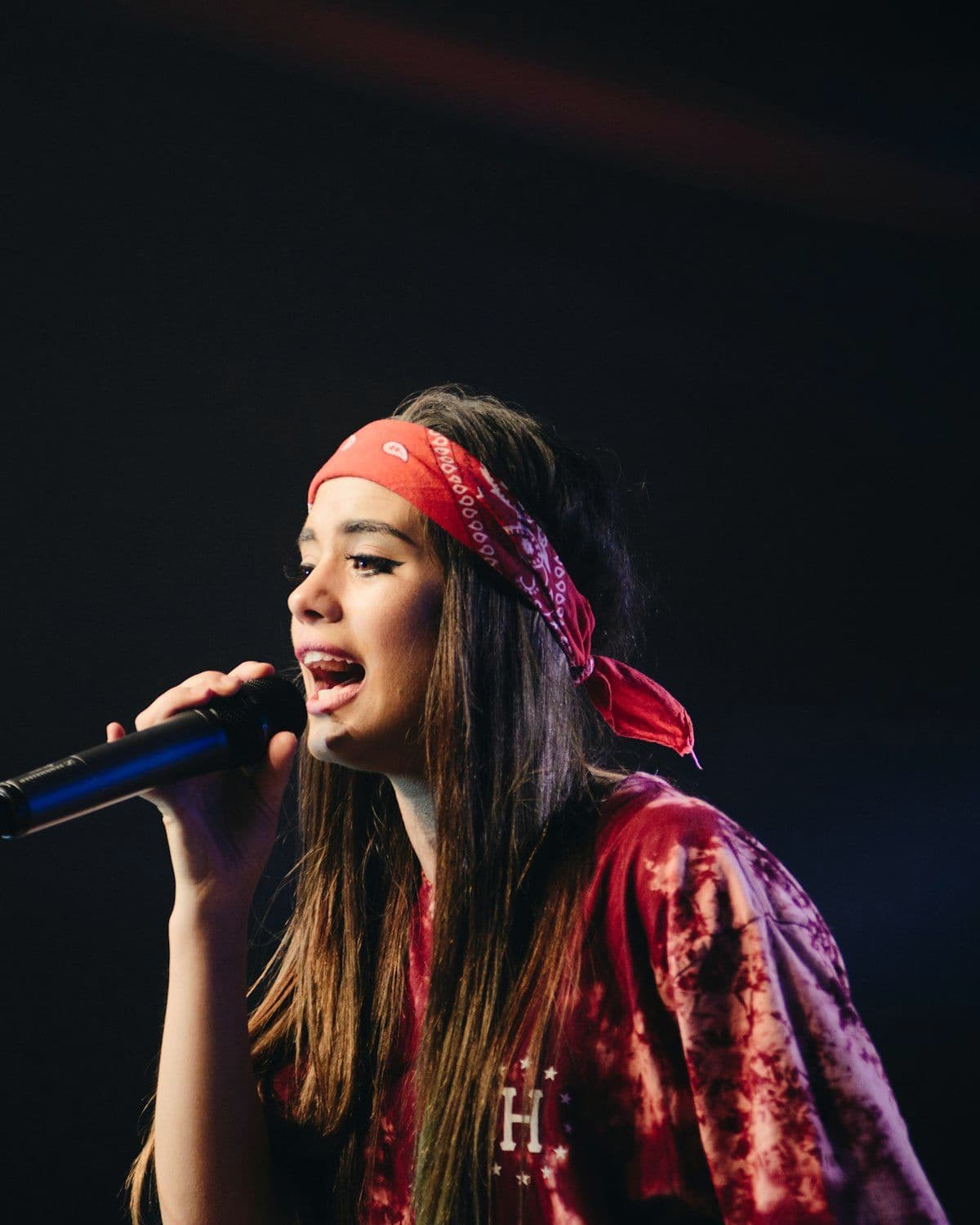 Vocalist performing with a microphone on stage
