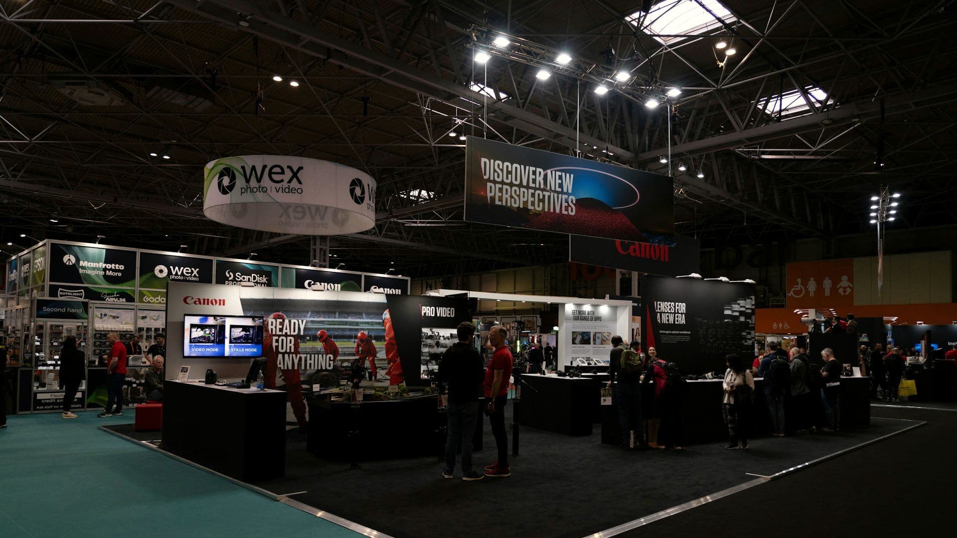 Visitors gathered around a brand stand at an exhibition