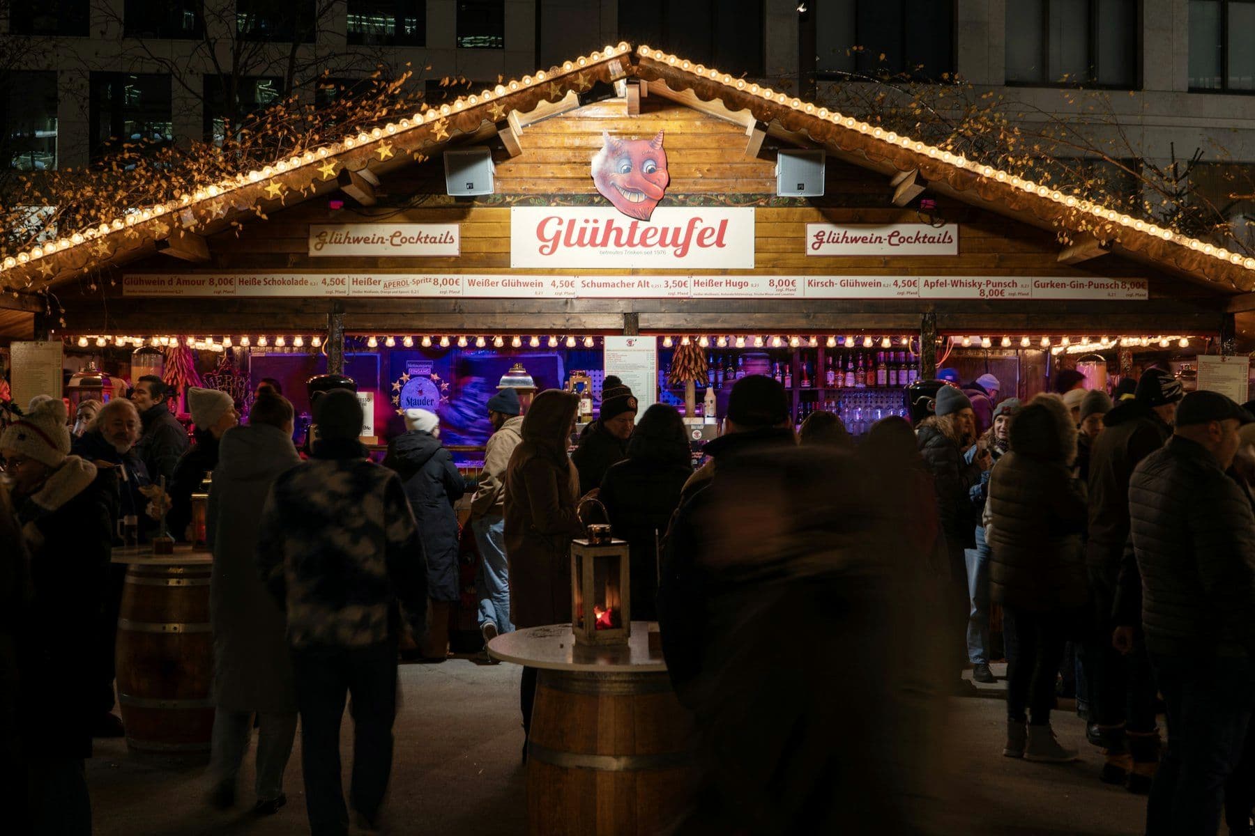 Visitors gathering at a festive stall in the evening