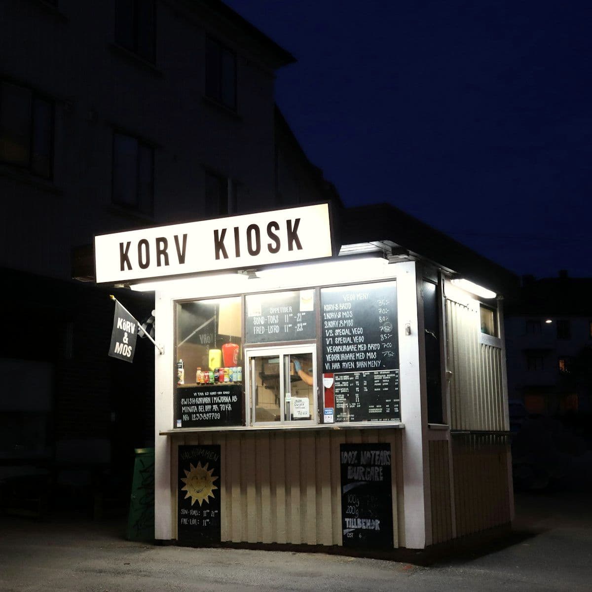 Compact pop-up kiosk lit up after dark