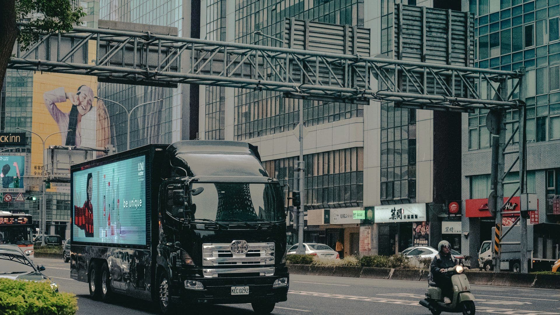 Branded vehicle carrying a digital billboard through the city
