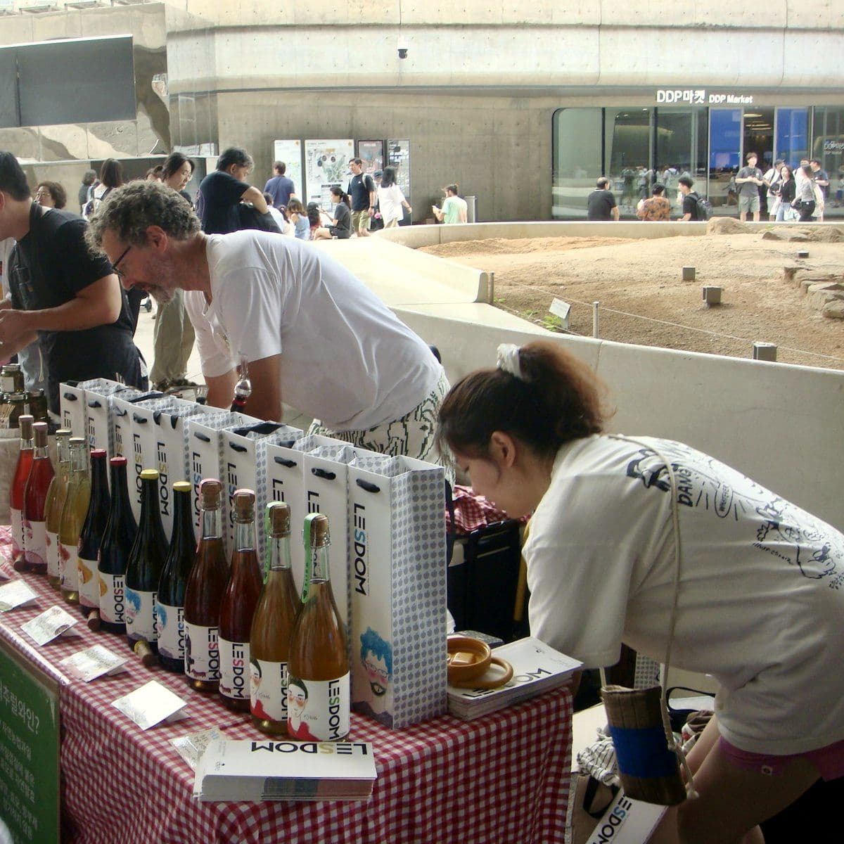 Visitors sampling products at an outdoor counter