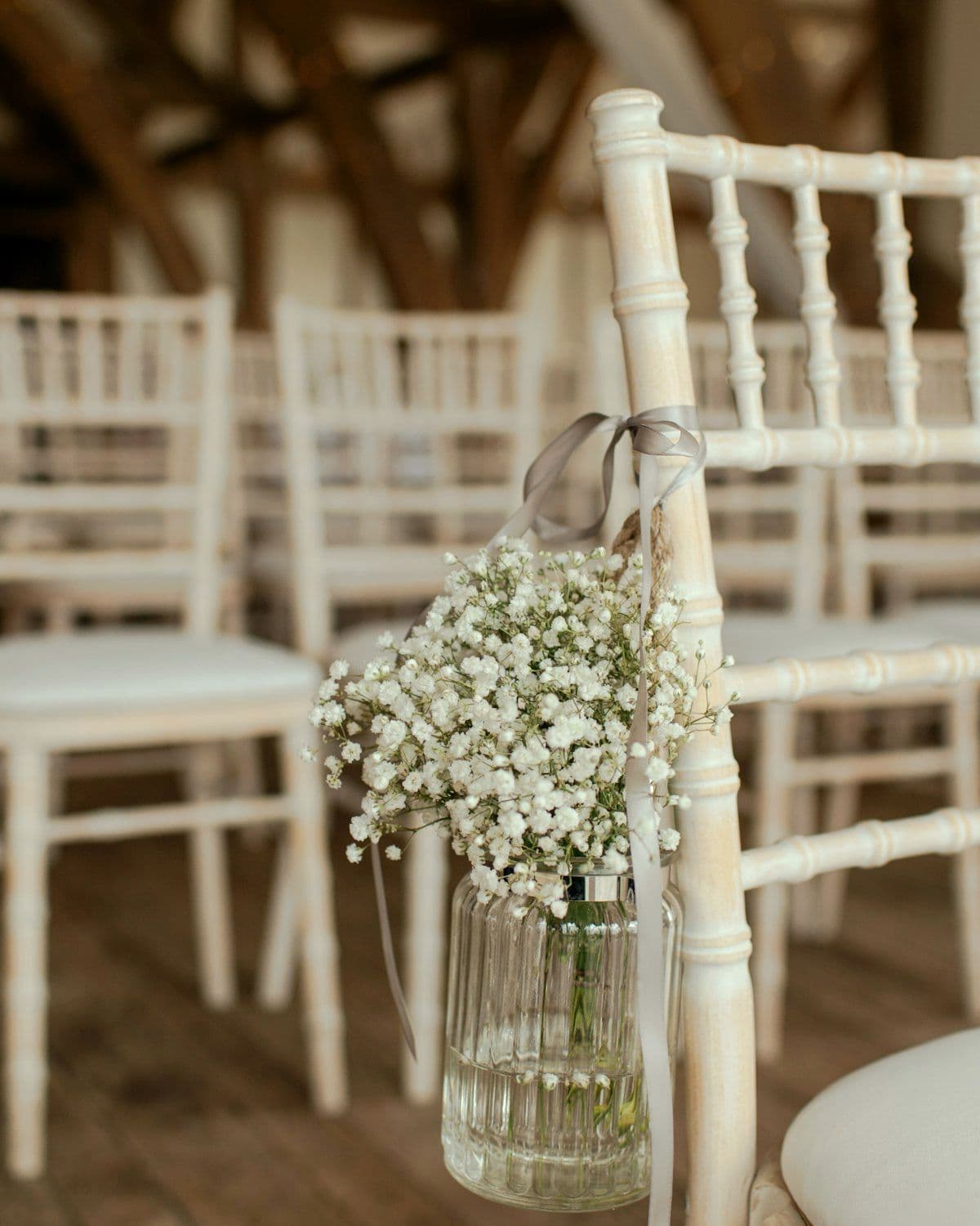 Suspended floral jars lining a ceremony aisle