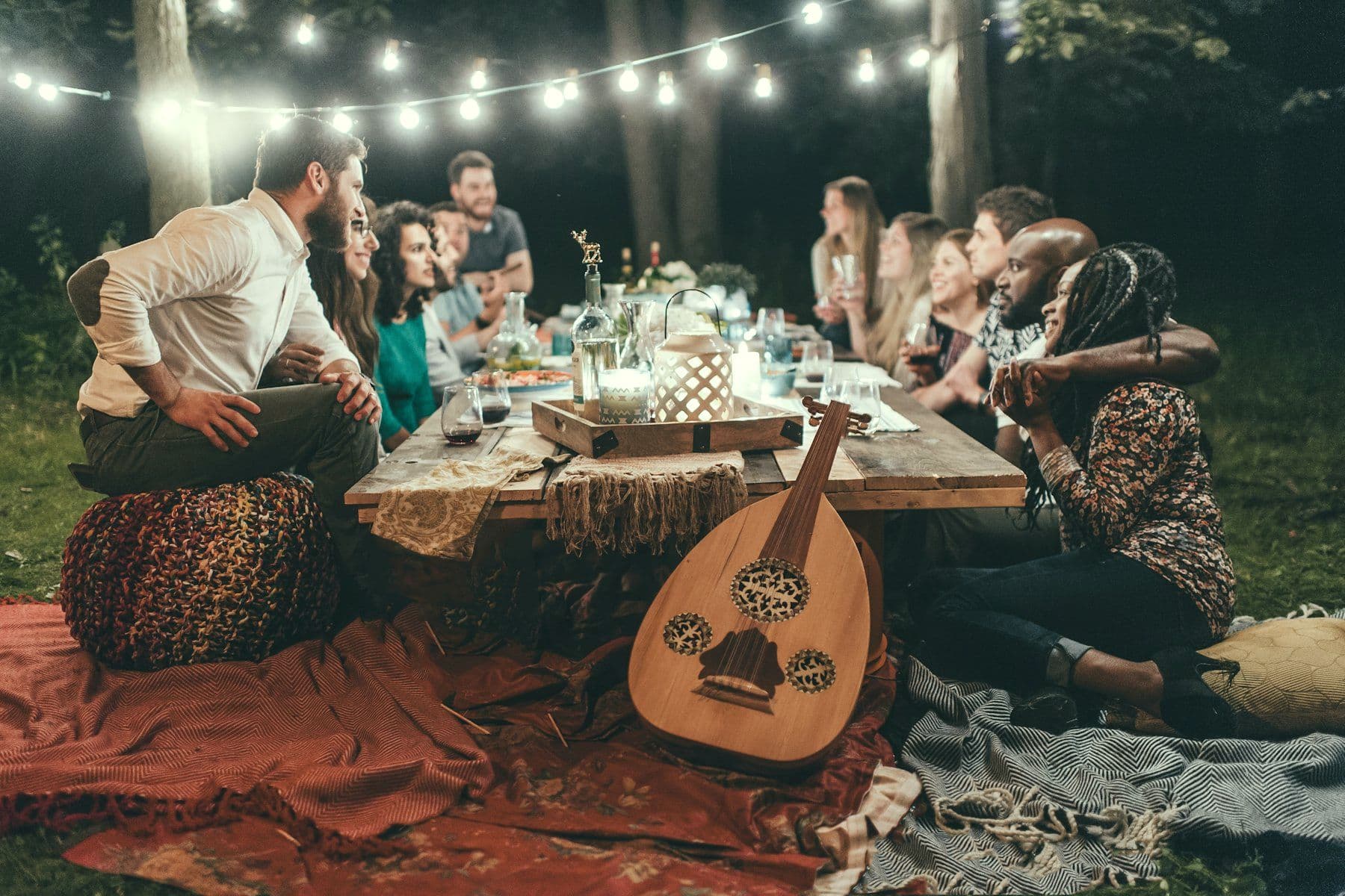 Open-air dinner setup under strung lighting