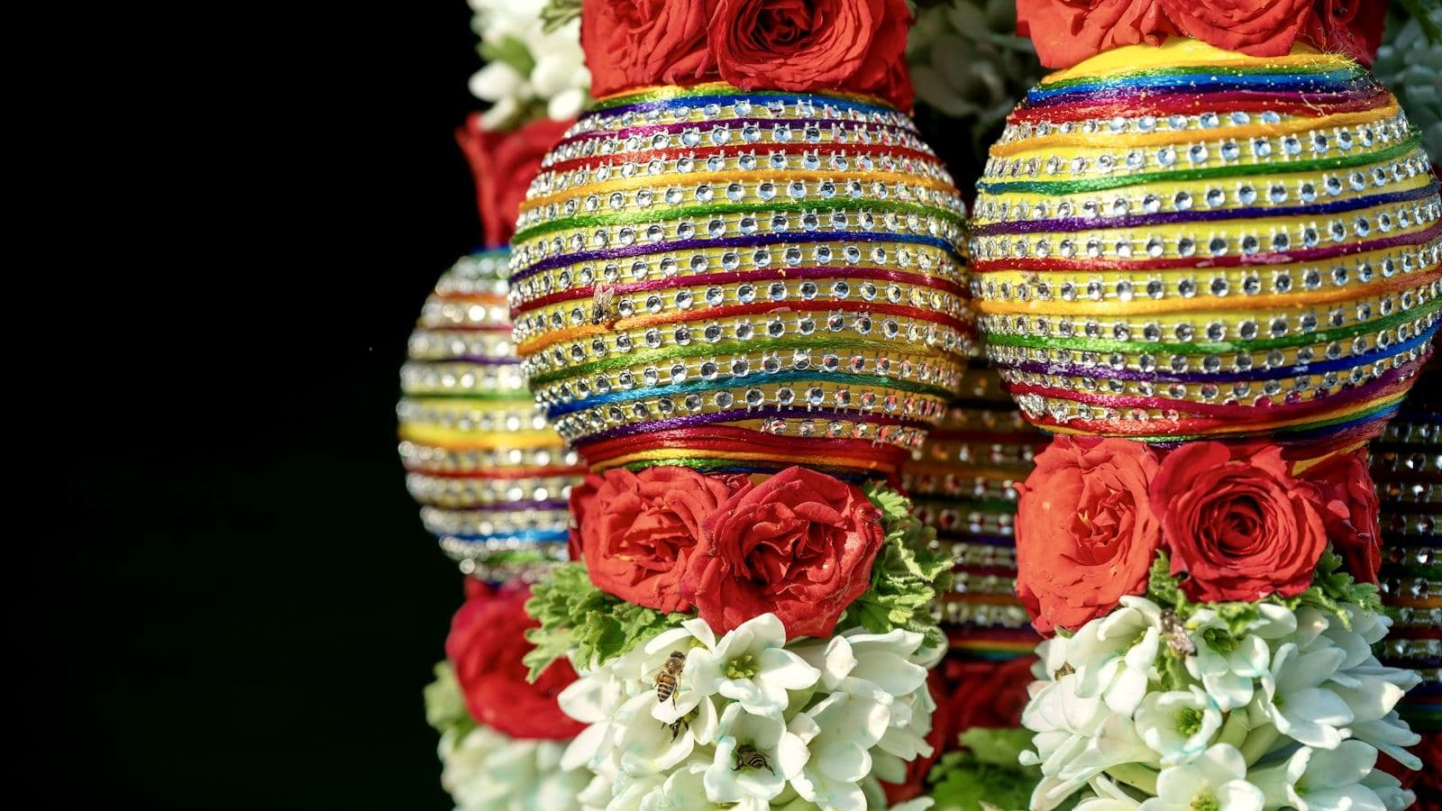 Decorated urns filled with roses and marigolds
