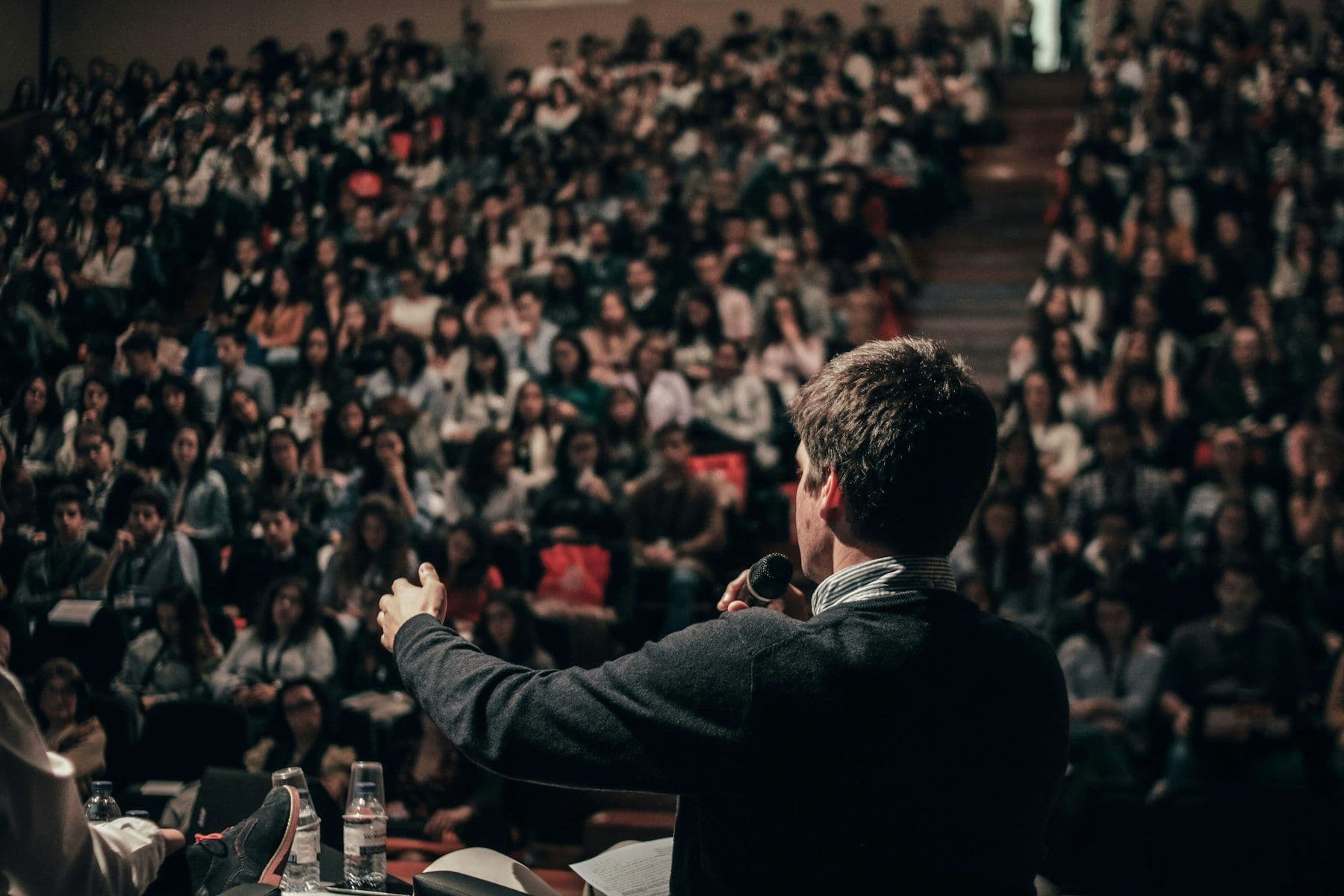 Speaker photographed on stage at a corporate event