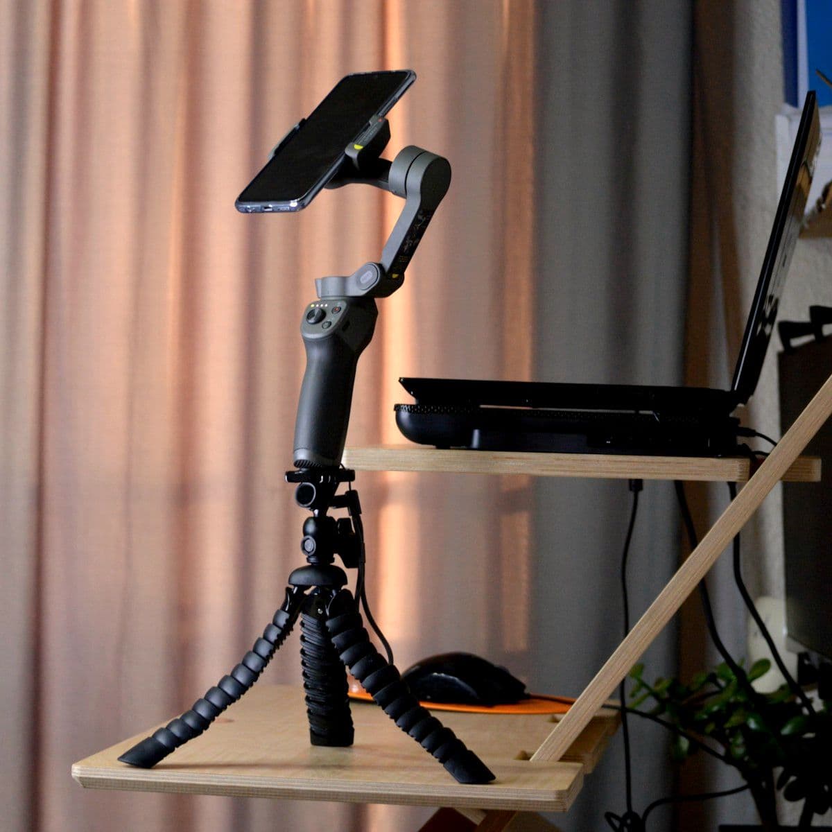 Camera set on a tripod beside natural window light
