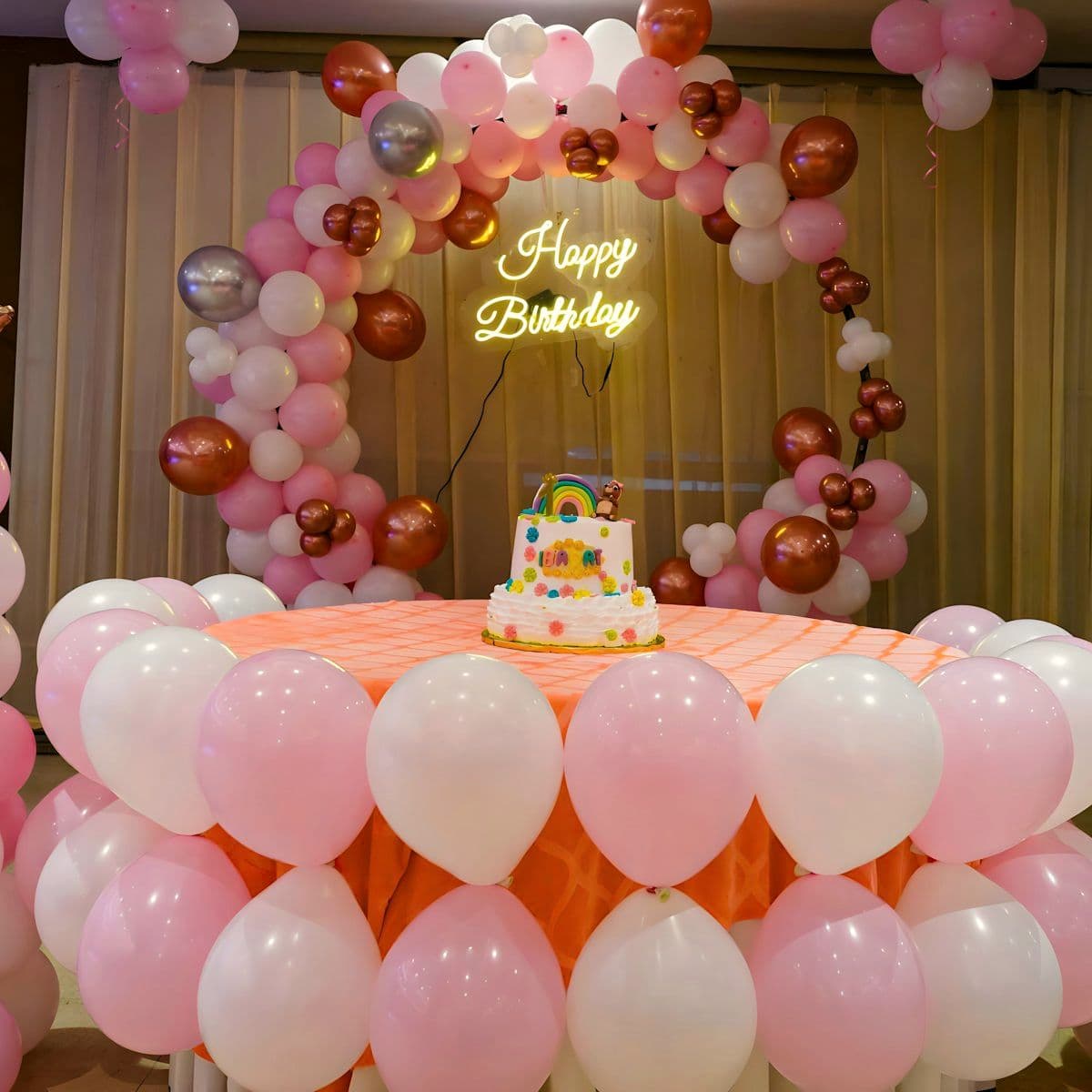 Birthday celebration styled with a balloon and floral installation
