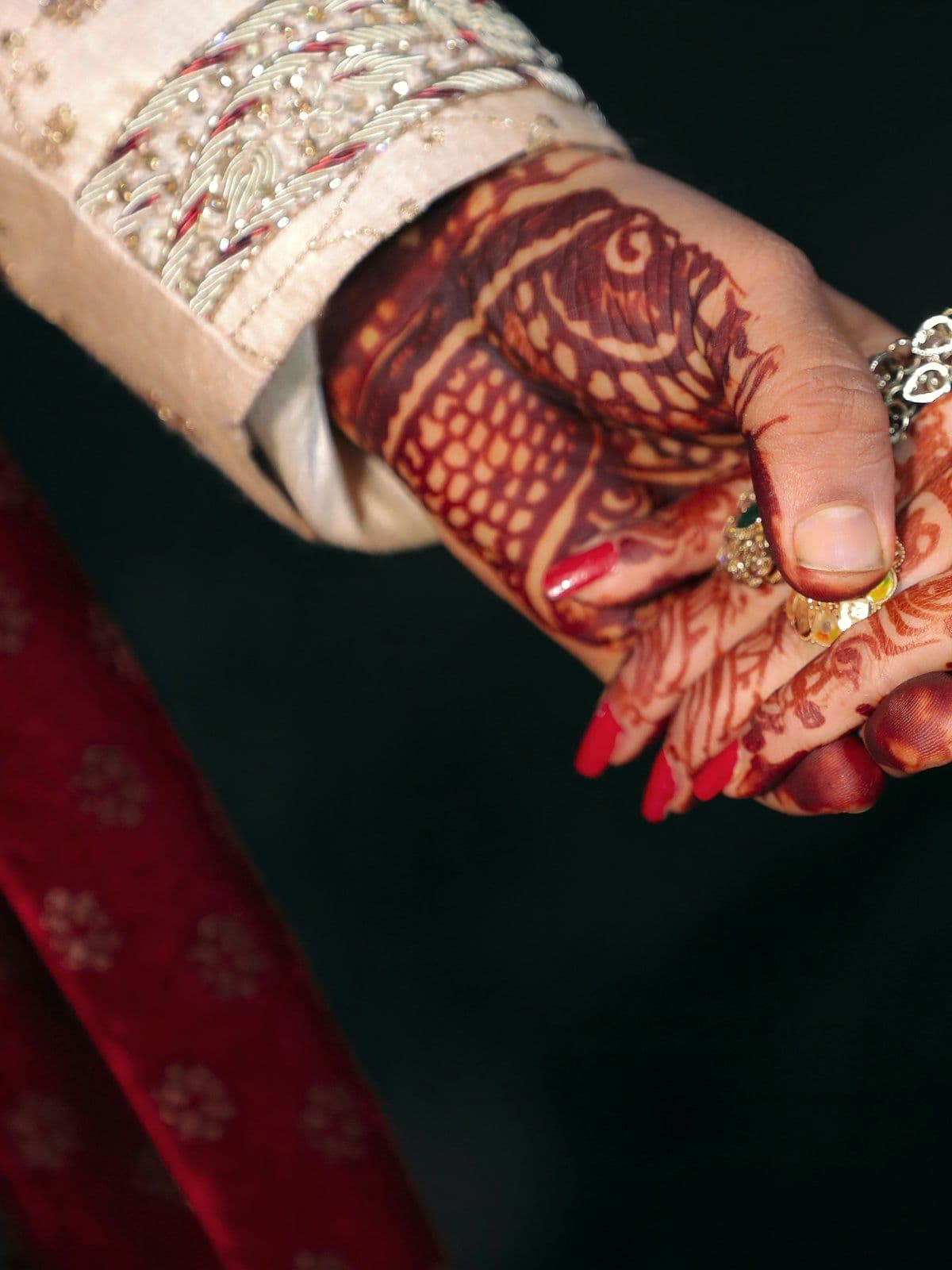Mehendi-decorated hands during an engagement ceremony