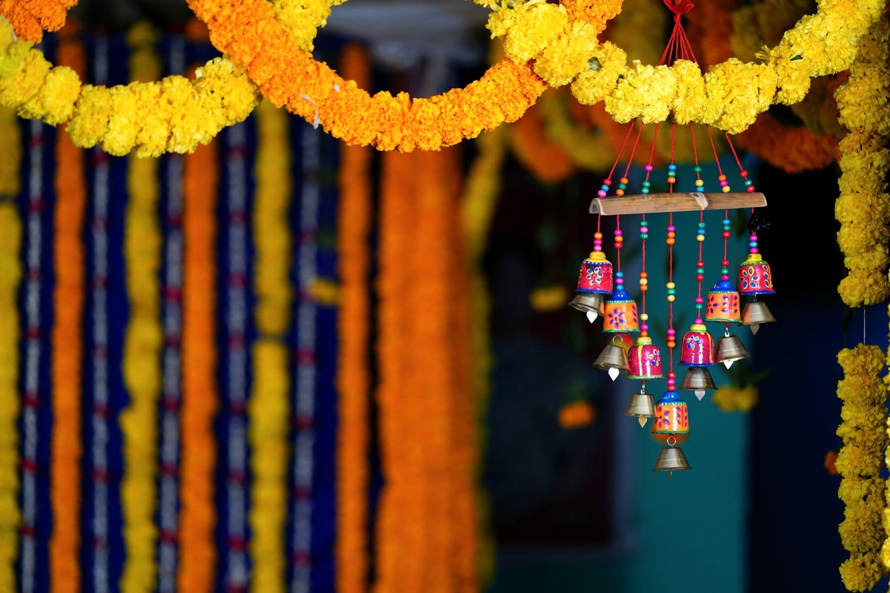 Festive hangings in marigold and colour above a courtyard