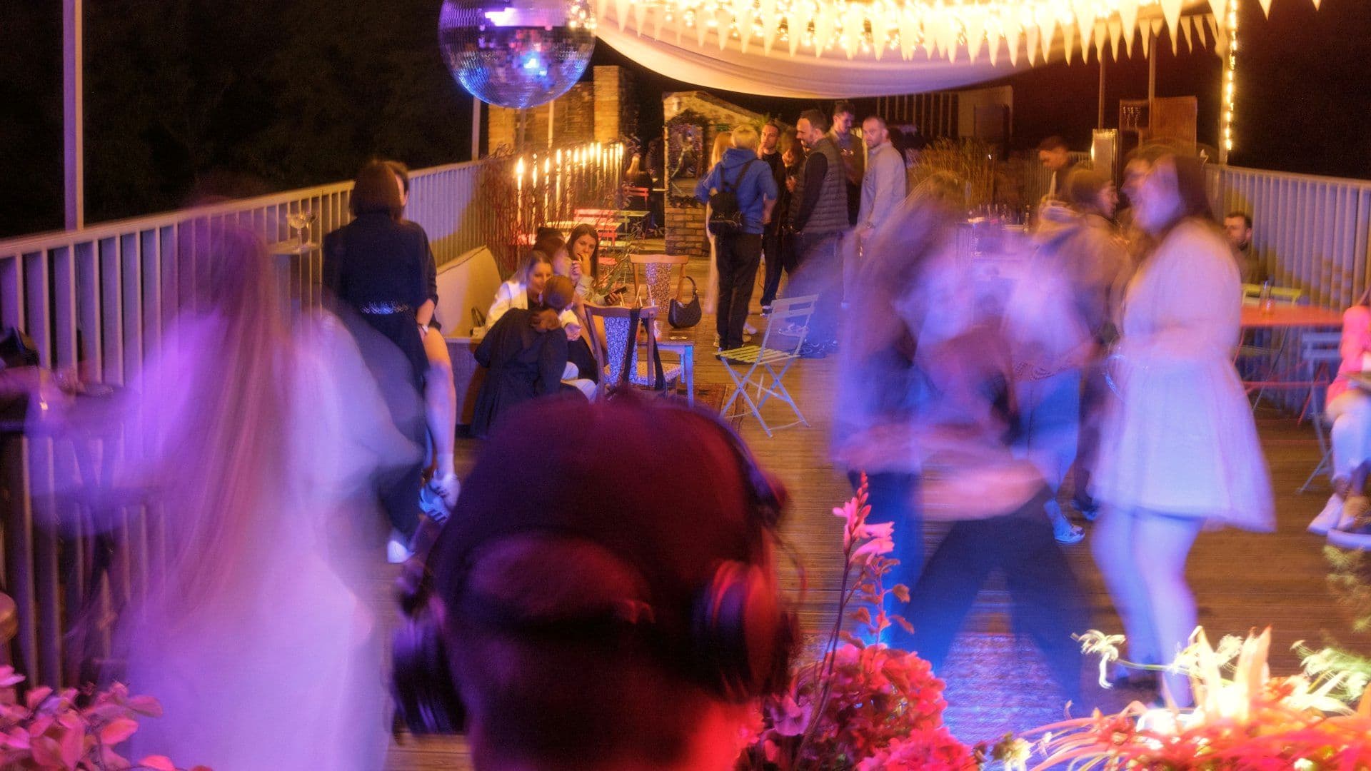 Guests dancing at an open-air evening celebration