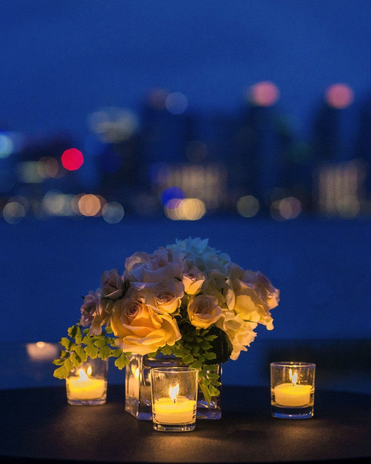Roses and candlelight on a private dinner table