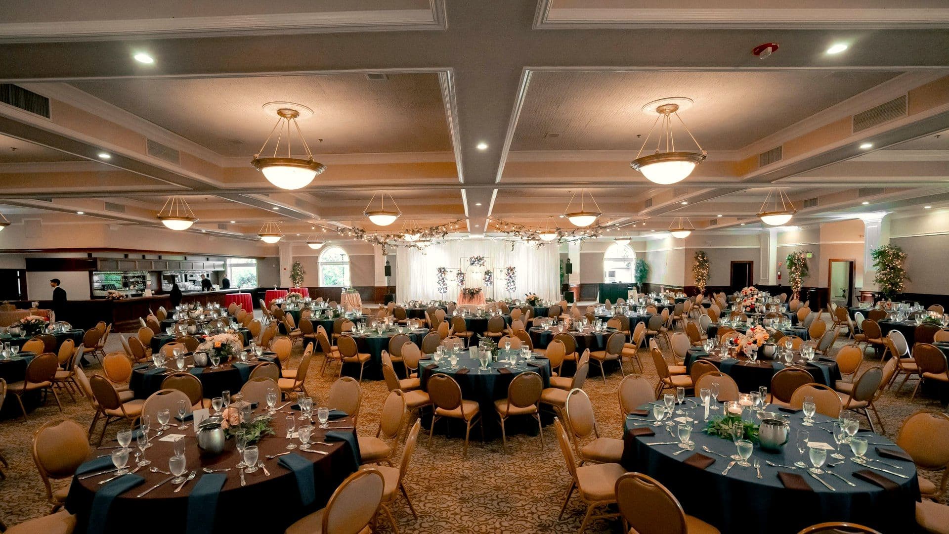 Ballroom laid with round tables ahead of a celebration