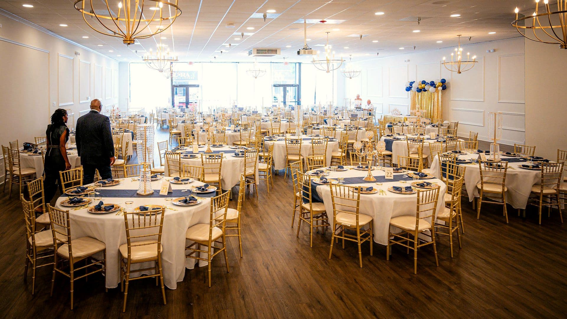 The same hall dressed with tables, chandeliers and lighting