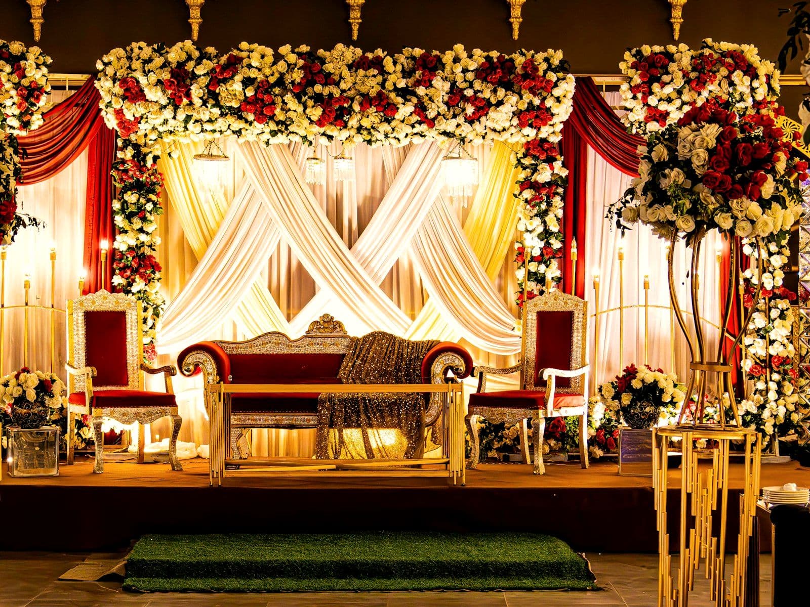 Mandap framed by drapery and floral columns