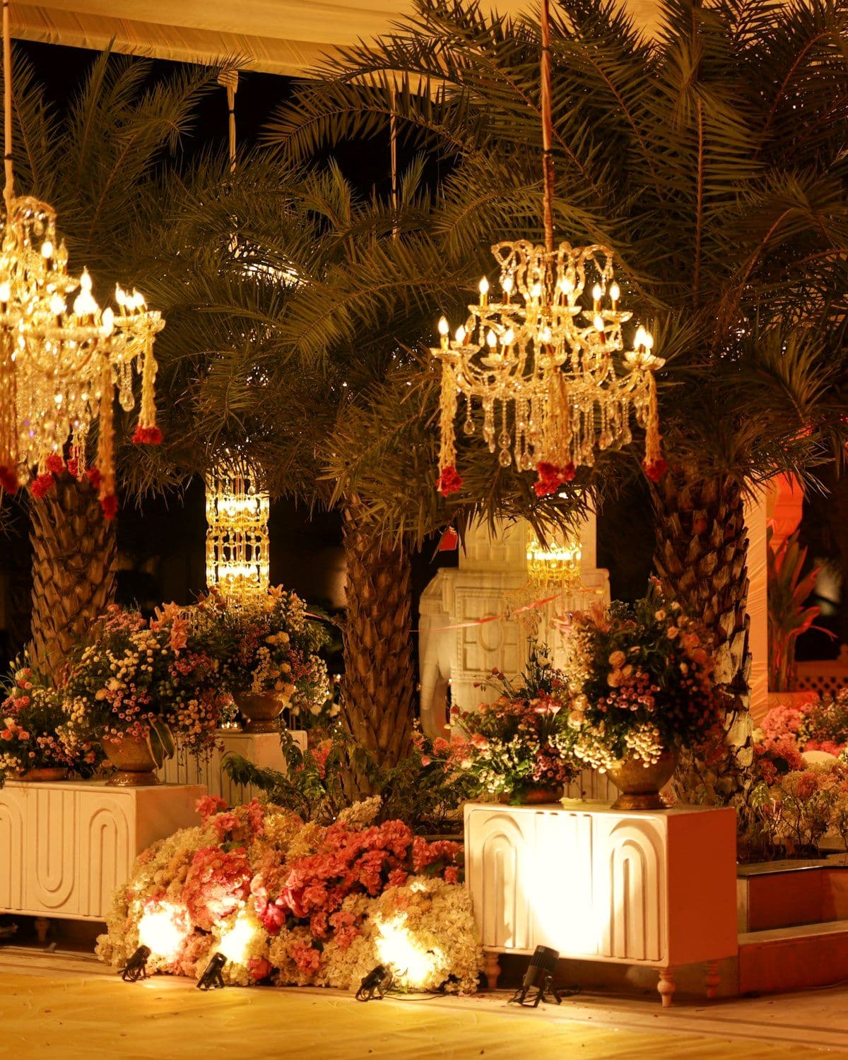 Reception hall dressed with chandeliers and floral arrangements