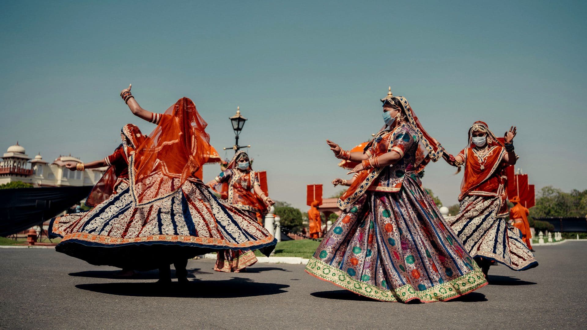 Performers in traditional dress mid-routine at the sangeet